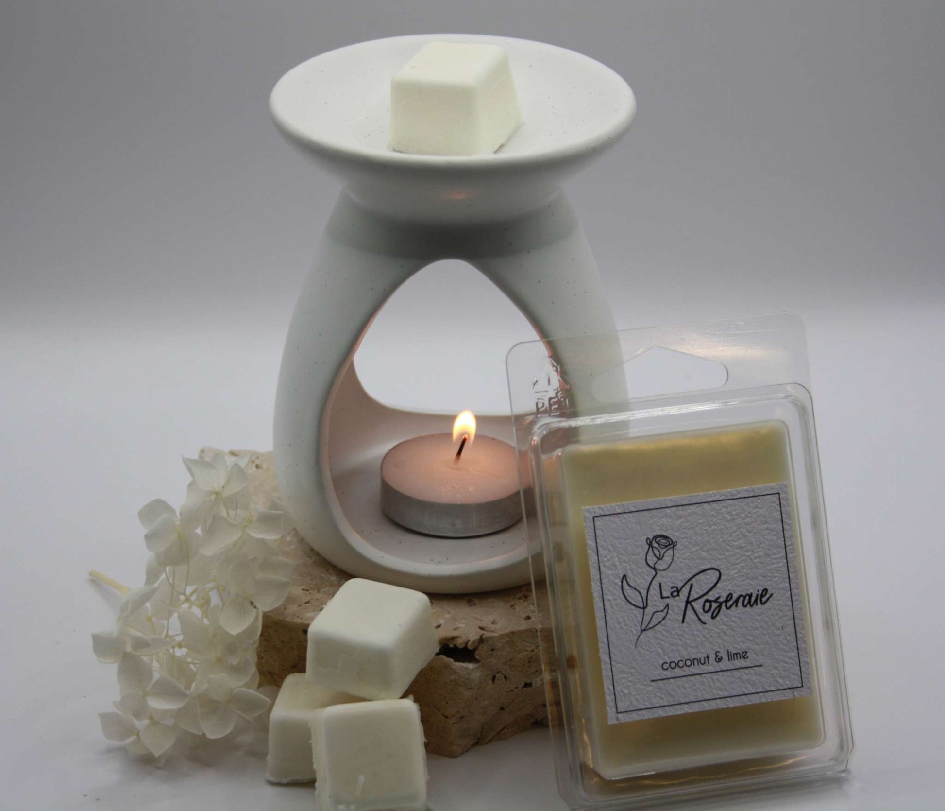 Wax Melt Classic Soy 6 Pack La Roseraie 6 pack soy wax melts. Coconut Lime fragrance, with wax melter alight.
